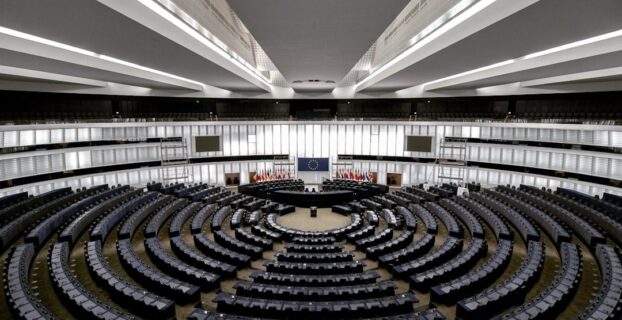 Empty European parliamentary chamber with semicircular rows of seats